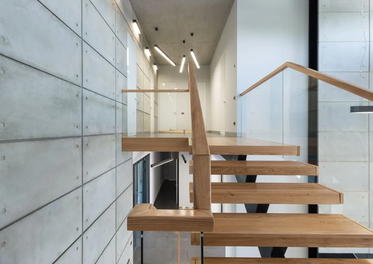 A floating staircase of pale wood and glass